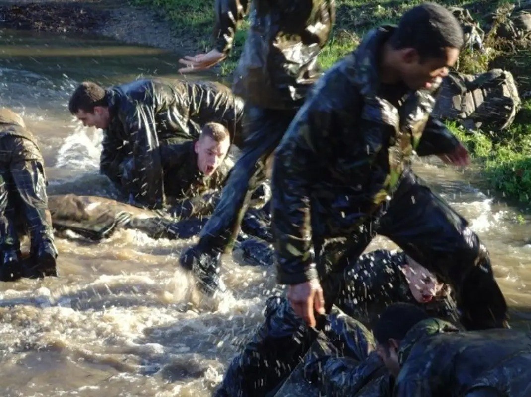 Soldiers crossing a river on a military training exercise